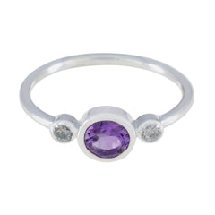 Naomi luxury purple gemstone ring with oval amethyst center and two small clear stones on silver band