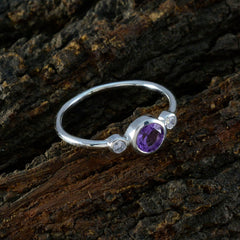 Naomi luxury purple gemstone ring with two small side stones in a silver band