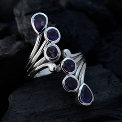 Yasmine modern blue gemstone ring with multiple deep blue stones set in silver on dark background