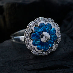 Noelia modern blue gemstone ring featuring a floral design with blue stones and surrounding clear accents