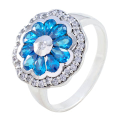 Noelia modern blue gemstone ring with flower-shaped blue stones and surrounding clear crystals