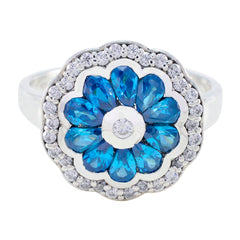 Noelia modern blue gemstone ring with floral design and sparkling clear stones on silver band