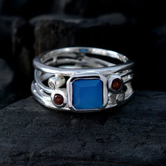Ayesha modern blue gemstone ring with square blue center stone and red accent stones on silver bands