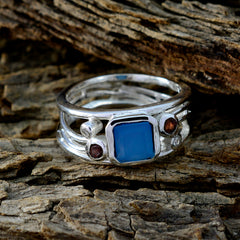 Ayesha modern blue gemstone ring featuring square blue center stone and garnet accent stones on silver band