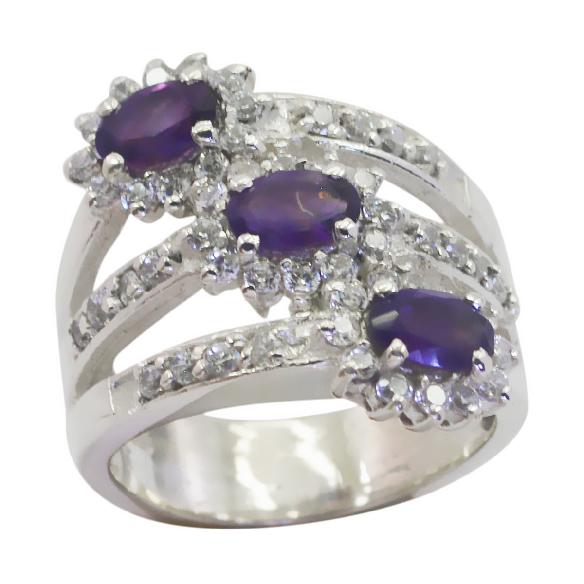 Claire modern blue trilogy ring with three deep purple oval stones and halo diamonds on split silver band