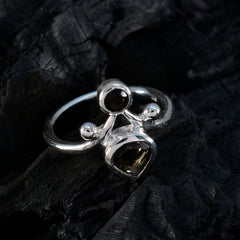 Sofia modern brown toi et moi ring with two brown gemstones set in silver band on dark textured background