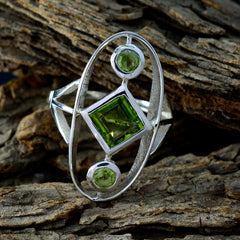 Sara modern green gemstone ring with square center stone and two round green accents in silver openwork setting