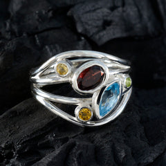 Isadora modern multicolor gemstone ring with red, blue, yellow, and green stones set in silver band