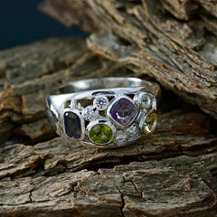 Sara silver band modern multicolor gemstone ring with amethyst peridot sapphire and diamond accents on rustic wood