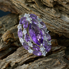 Lucia modern purple gemstone ring with marquise cut stones and sparkling white accents on textured wood