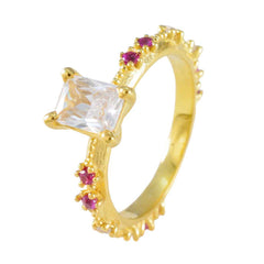 Liyana gold ring with square clear center stone and small red accents modern red gemstone ring