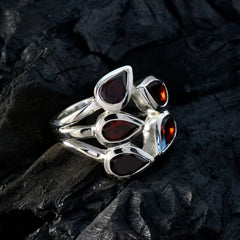 Natcha modern red gemstone ring with multiple teardrop-shaped red stones set in silver band