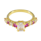Siti modern red gemstone ring gold band with rectangular clear center stone and alternating ruby and diamond accents