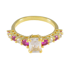 Siti modern red gemstone ring gold band with rectangular clear center stone and alternating ruby and diamond accents