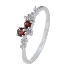 Mei modern red gemstone ring with two round red stones and small white accent diamonds on silver band
