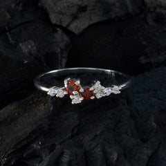Mei modern red gemstone ring featuring two round red gemstones and clear accent stones on sterling band