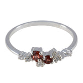 Mei modern red gemstone ring featuring two small round red stones and side white accent diamonds on thin silver band