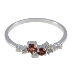 Mei modern red gemstone ring featuring two small round red stones and side white accent diamonds on thin silver band