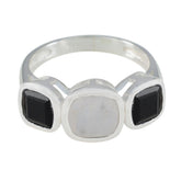 Ines silver modern trilogy ring with two black stones and one white stone in the center