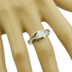 Audrey modern white solitaire ring with marquise stone set on a silver band worn on finger