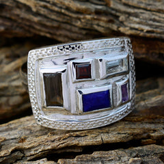 Ayesha multicolor cocktail ring with rectangular gemstones set in a wide silver band on rustic wood