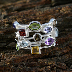 Isadora multicolor cocktail ring with various gemstones set in silver on rustic surface