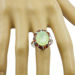 Araya multicolor cocktail ring with pale green oval center stone and red garnet halo on silver band