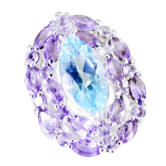 Teresa multicolor gemstone cocktail ring featuring a large blue center stone surrounded by purple gemstones