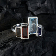Dewi multicolor gemstone cocktail ring with rectangular stones in silver setting on dark textured background