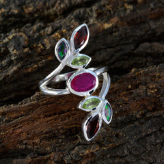 Audrey multicolor gemstone cocktail ring with silver band and assorted colorful stones on rustic wood