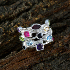 Julia multicolor gemstone cocktail ring in sterling silver with assorted colorful stones stacked design on wood