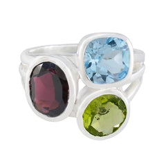 Chloe multicolor gemstone cocktail ring with blue, green, and red oval gemstones set in silver band