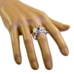 Riley multicolor gemstone cocktail ring with various shaped stones on a display hand