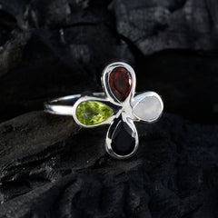Dewi multicolor gemstone floral ring with red, green, white, and black stones in silver setting