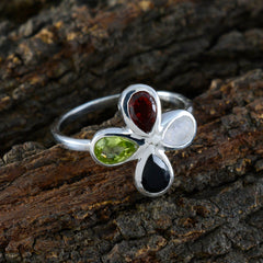 Dewi multicolor gemstone floral ring with red, green, white, and black gemstones on silver band