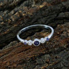 Natcha multicolor gemstone penta ring with five stones on silver band on textured bark