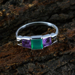 multicolor gemstone ring with square green center stone flanked by two purple square stones on a silver band