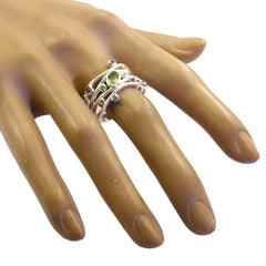 Rebeca multicolor gemstone statement ring with green stones on silver band displayed on hand model
