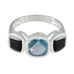 Nisa multicolor gemstone trilogy ring with a blue center stone and two black side stones in silver setting