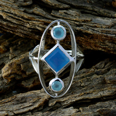 Lili silver multicolor gemstone trilogy ring with blue and aqua stones on textured wood background