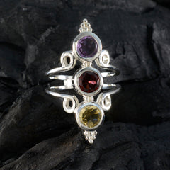 Priya silver multicolor gemstone trilogy ring with purple, red, and yellow stones on dark background