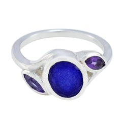 Putri multicolor gemstone trilogy ring featuring central deep blue round stone and two purple marquise side stones in silver band