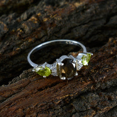Naomi multicolor gemstone trilogy ring featuring oval and pear shaped green and brown stones set in silver