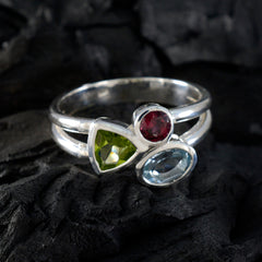 Lorena multicolor gemstone trilogy ring with red, green, and blue stones set in silver band