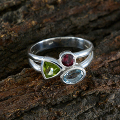 Lorena multicolor gemstone trilogy ring with green, red, and blue stones set in silver band