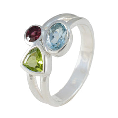 Lorena multicolor gemstone trilogy ring with red, blue, and green gemstones set in silver band
