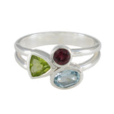 Lorena multicolor gemstone trilogy ring with green, red, and blue gemstones set in silver band
