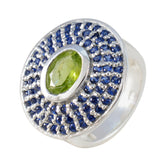 Putri multicolor halo cocktail ring with oval green center gemstone surrounded by blue pave stones on silver band