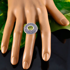 Putri multicolor halo cocktail ring with green center stone and blue halo on silver band worn on display hand