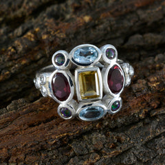 Multicolor Navratna cocktail ring with various gemstones set in silver band by Maria